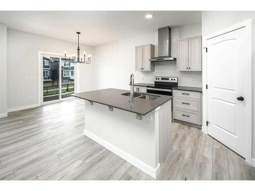 86 Belmont Passage Sw, Calgary, AB - Indoor Photo Showing Kitchen With Double Sink With Upgraded Kitchen