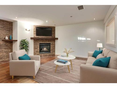 27 Kingsland Way Se, Airdrie, AB - Indoor Photo Showing Living Room With Fireplace