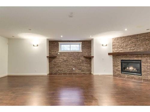 27 Kingsland Way Se, Airdrie, AB - Indoor Photo Showing Living Room With Fireplace