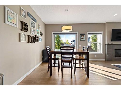 15 Walden Place Se, Calgary, AB - Indoor Photo Showing Dining Room With Fireplace