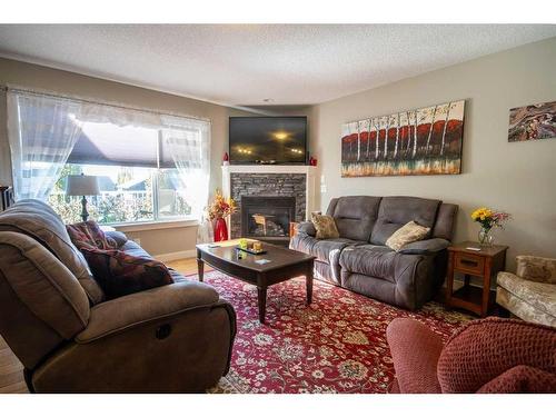 37 Bluebird Drive Se, Didsbury, AB - Indoor Photo Showing Living Room With Fireplace