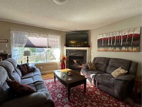 37 Bluebird Drive Se, Didsbury, AB - Indoor Photo Showing Living Room With Fireplace