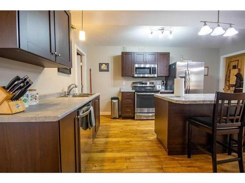 37 Bluebird Drive Se, Didsbury, AB - Indoor Photo Showing Kitchen With Double Sink