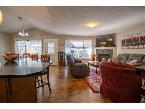 37 Bluebird Drive Se, Didsbury, AB - Indoor Photo Showing Living Room With Fireplace