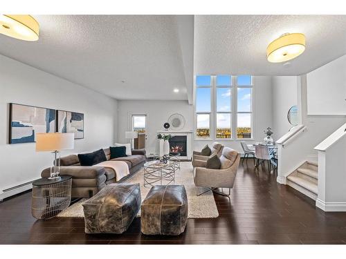 2307-10221 Tuscany Boulevard Nw, Calgary, AB - Indoor Photo Showing Living Room With Fireplace