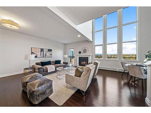 2307-10221 Tuscany Boulevard Nw, Calgary, AB - Indoor Photo Showing Living Room With Fireplace