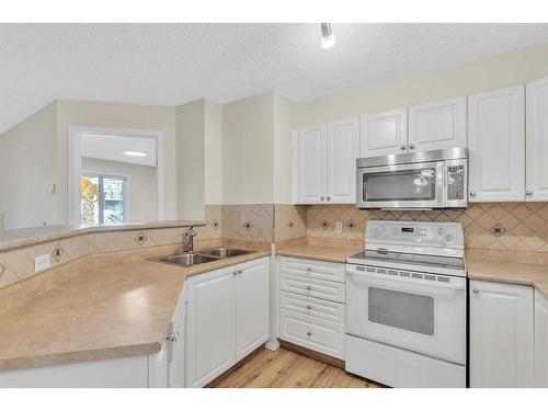 8317-304 Mackenzie Way Sw, Airdrie, AB - Indoor Photo Showing Kitchen With Double Sink