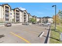 8317-304 Mackenzie Way Sw, Airdrie, AB  - Outdoor With Balcony With Facade 