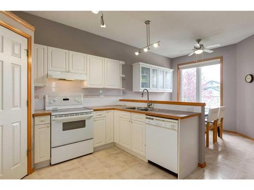 12 Big Springs Rise Se, Airdrie, AB - Indoor Photo Showing Kitchen With Double Sink