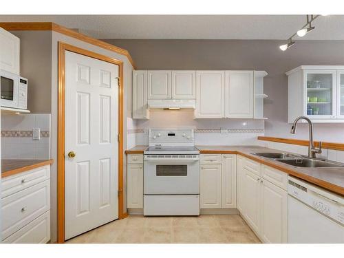 12 Big Springs Rise Se, Airdrie, AB - Indoor Photo Showing Kitchen With Double Sink