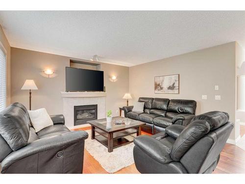 28 Simcrest Point Sw, Calgary, AB - Indoor Photo Showing Living Room With Fireplace