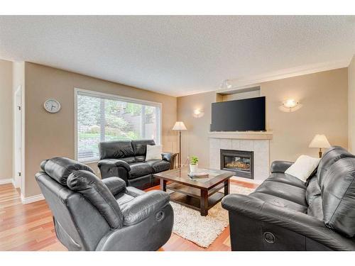 28 Simcrest Point Sw, Calgary, AB - Indoor Photo Showing Living Room With Fireplace