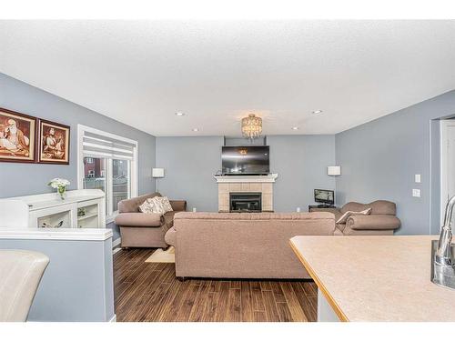 151 Saddlehorn Close Ne, Calgary, AB - Indoor Photo Showing Living Room With Fireplace