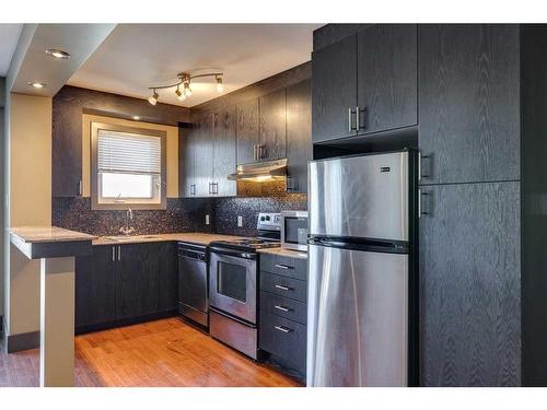 303-1736 13 Avenue Sw, Calgary, AB - Indoor Photo Showing Kitchen With Stainless Steel Kitchen