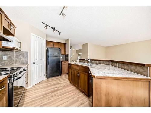 273 New Brighton Lane Se, Calgary, AB - Indoor Photo Showing Kitchen With Double Sink