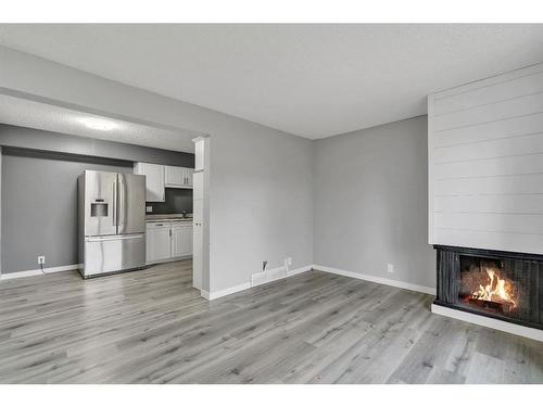 5-6408 4A Street Ne, Calgary, AB - Indoor Photo Showing Other Room With Fireplace