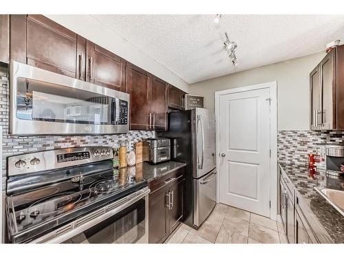 415-15 Saddlestone Way Ne, Calgary, AB - Indoor Photo Showing Kitchen With Stainless Steel Kitchen With Upgraded Kitchen