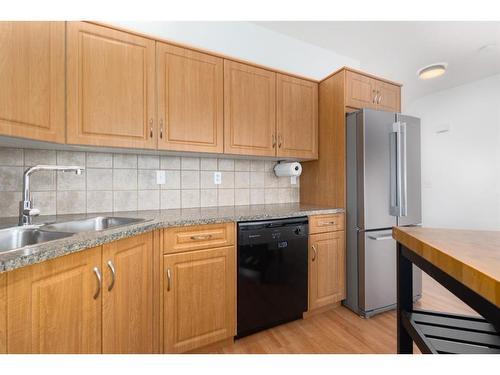 8-249 Ross Avenue, Cochrane, AB - Indoor Photo Showing Kitchen With Double Sink