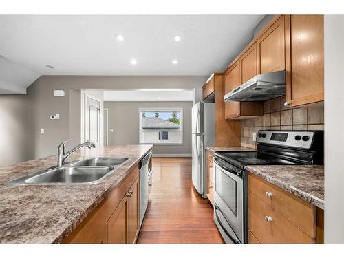 1031 Hammond Avenue, Crossfield, AB - Indoor Photo Showing Kitchen With Stainless Steel Kitchen With Double Sink