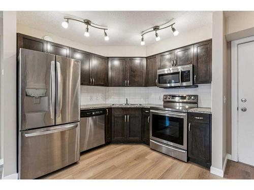 107-2000 Applevillage Court Se, Calgary, AB - Indoor Photo Showing Kitchen With Stainless Steel Kitchen With Double Sink