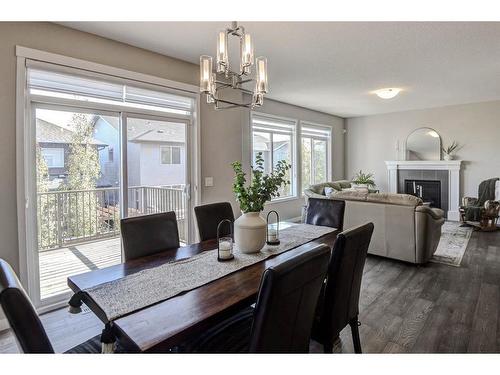 100 Sage Bluff Close Nw, Calgary, AB - Indoor Photo Showing Dining Room With Fireplace