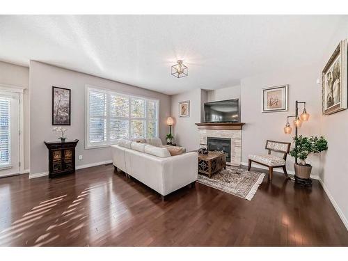 170 Crestmont Drive Sw, Calgary, AB - Indoor Photo Showing Living Room With Fireplace