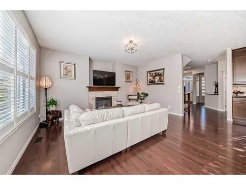 170 Crestmont Drive Sw, Calgary, AB - Indoor Photo Showing Living Room With Fireplace