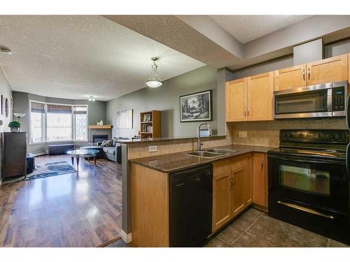 403-5720 2 Street Sw, Calgary, AB - Indoor Photo Showing Kitchen With Double Sink