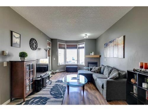 403-5720 2 Street Sw, Calgary, AB - Indoor Photo Showing Living Room With Fireplace