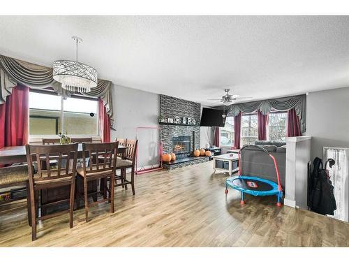 48 Sandpiper Way Nw, Calgary, AB - Indoor Photo Showing Dining Room With Fireplace