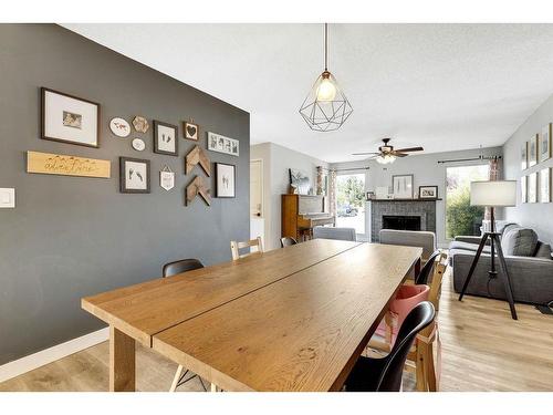 112 Hodson Crescent, Okotoks, AB - Indoor Photo Showing Dining Room With Fireplace