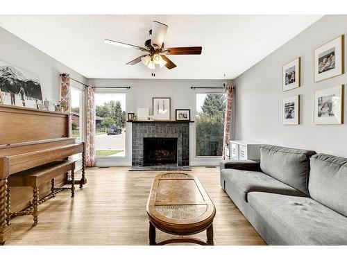 112 Hodson Crescent, Okotoks, AB - Indoor Photo Showing Living Room With Fireplace