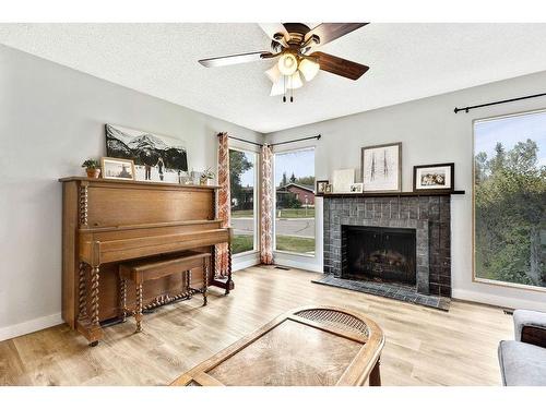 112 Hodson Crescent, Okotoks, AB - Indoor Photo Showing Living Room With Fireplace