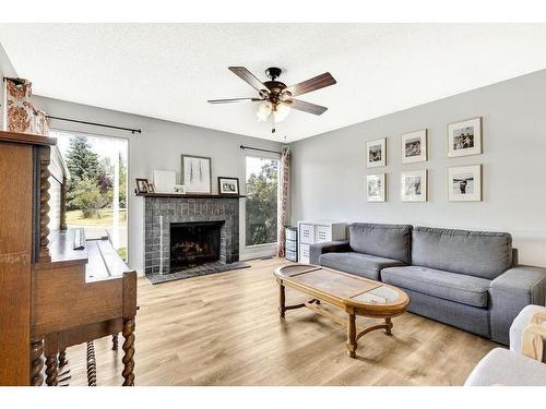 112 Hodson Crescent, Okotoks, AB - Indoor Photo Showing Living Room With Fireplace