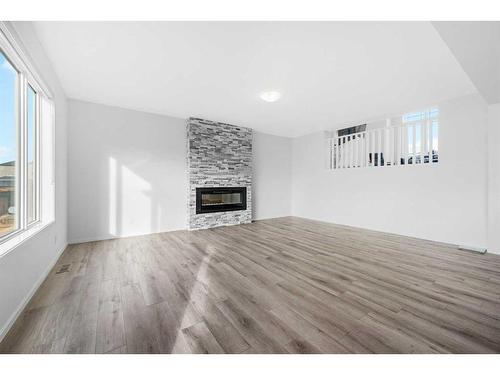 801 Windrow Green Sw, Airdrie, AB - Indoor Photo Showing Living Room With Fireplace