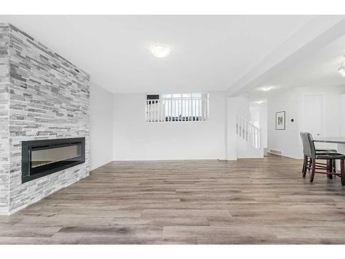 801 Windrow Green Sw, Airdrie, AB - Indoor Photo Showing Living Room With Fireplace