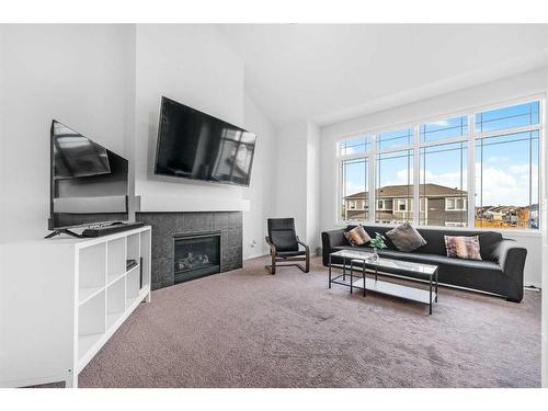 801 Windrow Green Sw, Airdrie, AB - Indoor Photo Showing Living Room With Fireplace