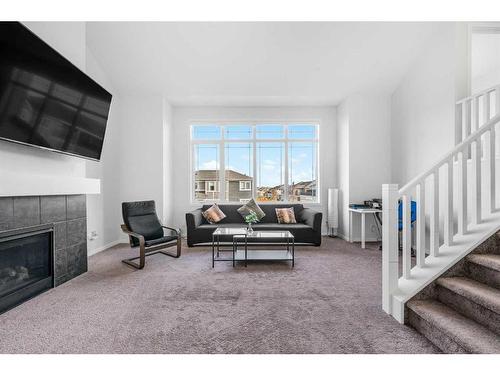 801 Windrow Green Sw, Airdrie, AB - Indoor Photo Showing Living Room With Fireplace