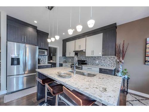 14 Baysprings Terrace Sw, Airdrie, AB - Indoor Photo Showing Kitchen With Double Sink With Upgraded Kitchen