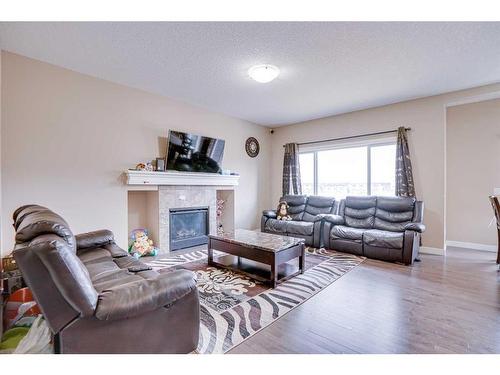 56 Red Embers Sq Ne Square West, Calgary, AB - Indoor Photo Showing Living Room With Fireplace