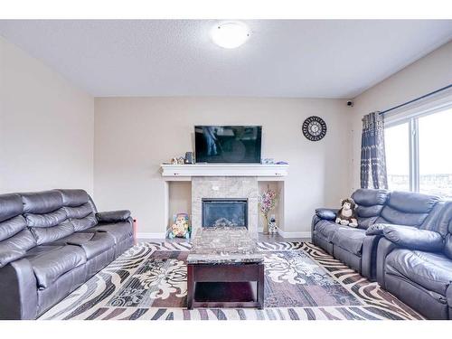 56 Red Embers Sq Ne Square West, Calgary, AB - Indoor Photo Showing Living Room With Fireplace