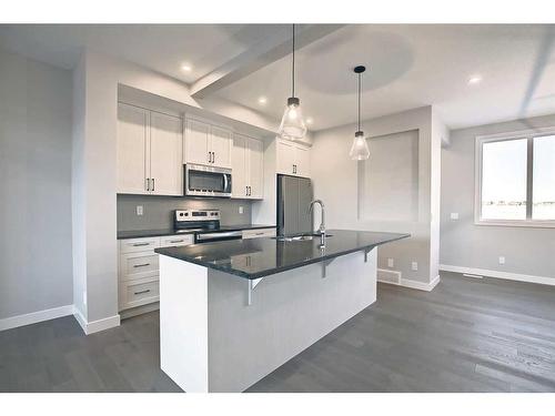 310 Sundown Road, Cochrane, AB - Indoor Photo Showing Kitchen With Stainless Steel Kitchen With Upgraded Kitchen