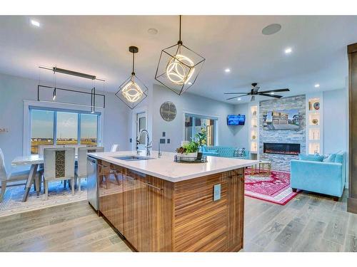 22 Chelsea Bay, Chestermere, AB - Indoor Photo Showing Kitchen With Fireplace