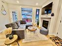 202I-209 Stewart Creek Rise, Canmore, AB  - Indoor Photo Showing Living Room With Fireplace 