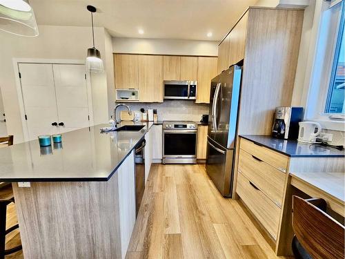 202I-209 Stewart Creek Rise, Canmore, AB - Indoor Photo Showing Kitchen With Stainless Steel Kitchen With Upgraded Kitchen