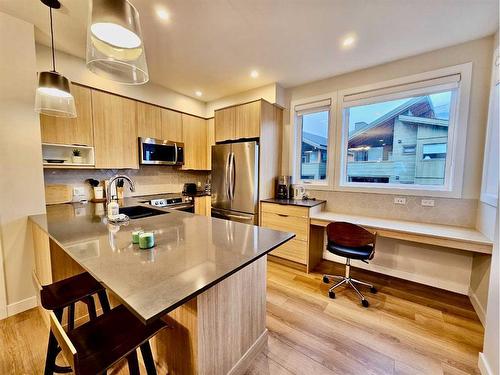 202I-209 Stewart Creek Rise, Canmore, AB - Indoor Photo Showing Kitchen With Stainless Steel Kitchen