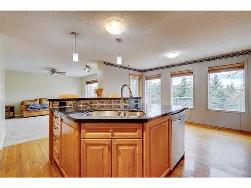 159 Gleneagles View, Cochrane, AB - Indoor Photo Showing Kitchen With Double Sink