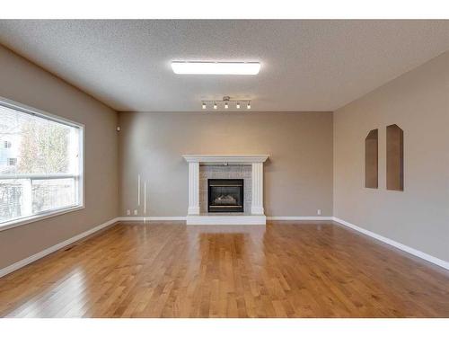 10349 Tuscany Hills Way Nw, Calgary, AB - Indoor Photo Showing Living Room With Fireplace