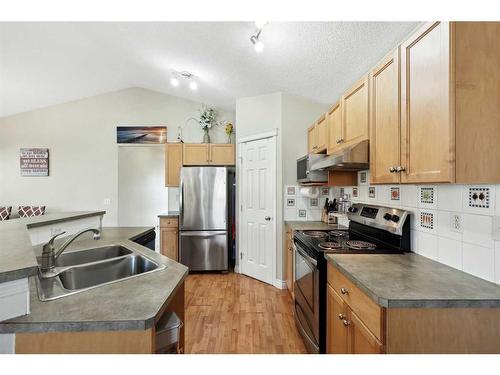 1056 Bridlemeadows Manor Sw, Calgary, AB - Indoor Photo Showing Kitchen With Double Sink