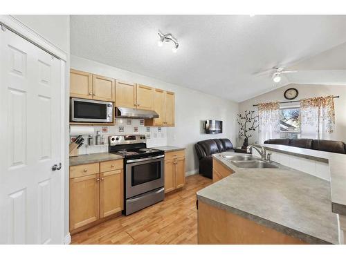 1056 Bridlemeadows Manor Sw, Calgary, AB - Indoor Photo Showing Kitchen With Double Sink